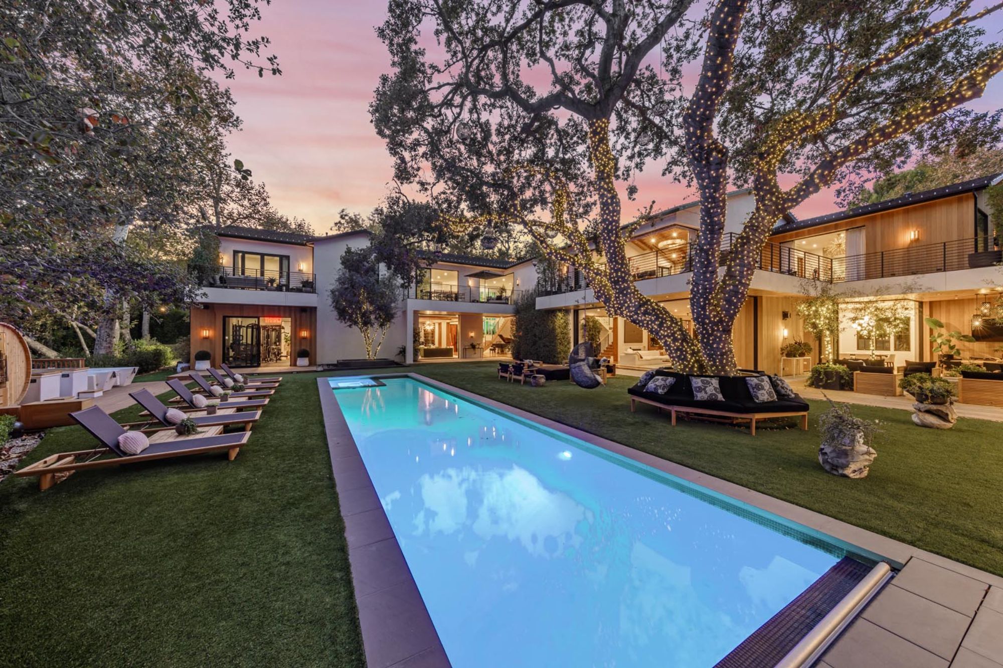 A big californa estate with a fancy pool in its backyard.