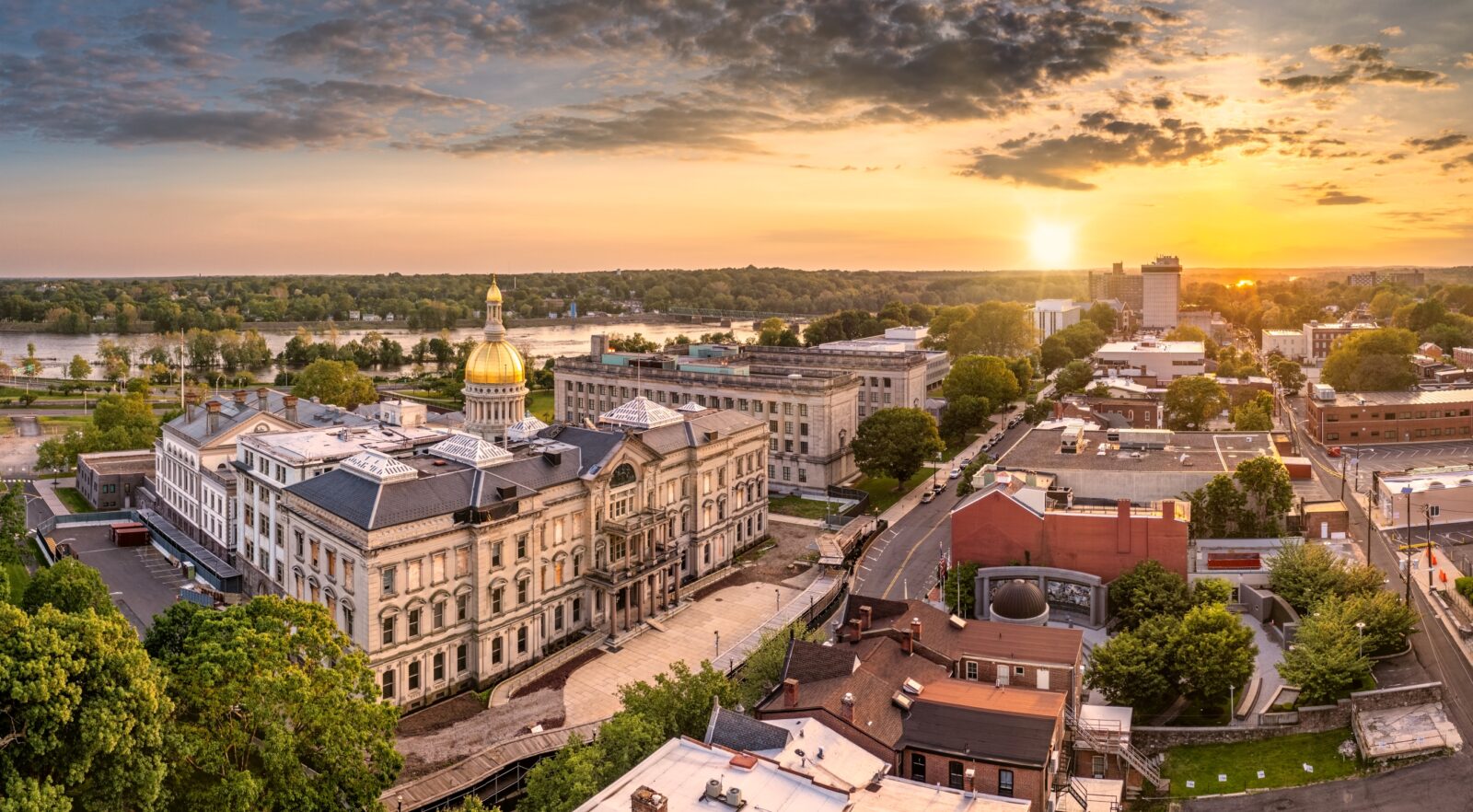 Buildings in Trenton, New Jersey under the light of a setting sun.