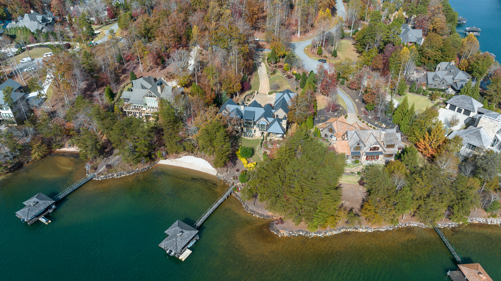 An overhead view of several big houses on lake Keowee.