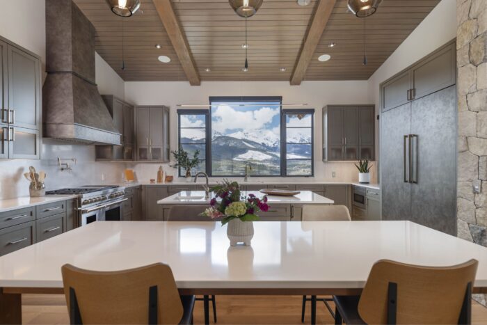 Kitchen in modern mountain home with quartz countertops and custom cabinetry. 