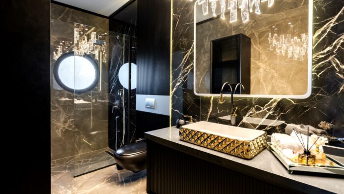 Stone-clad bathroom with walk-in shower. 