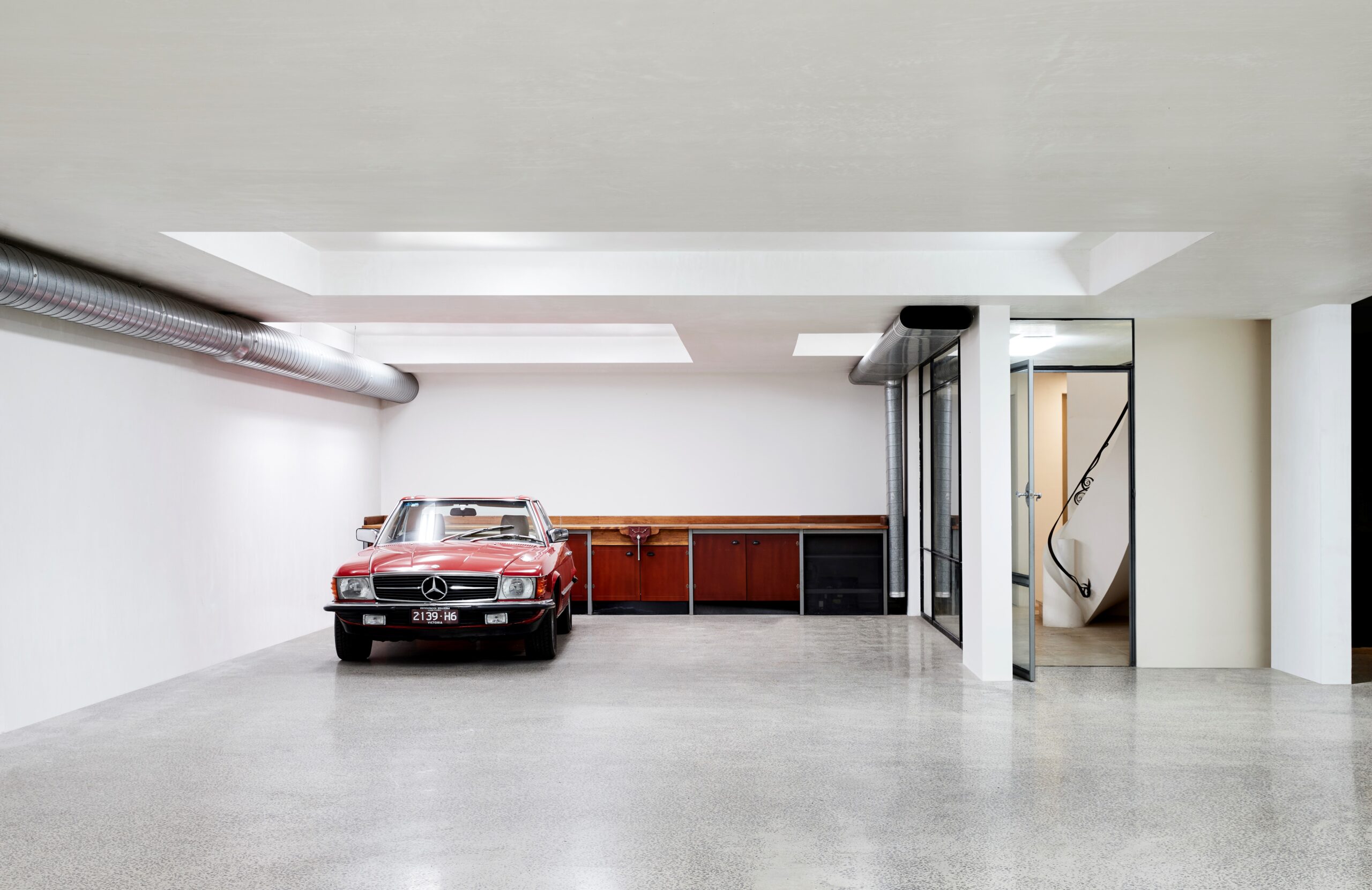 vintage Mercedes convertible in a minimalist garage