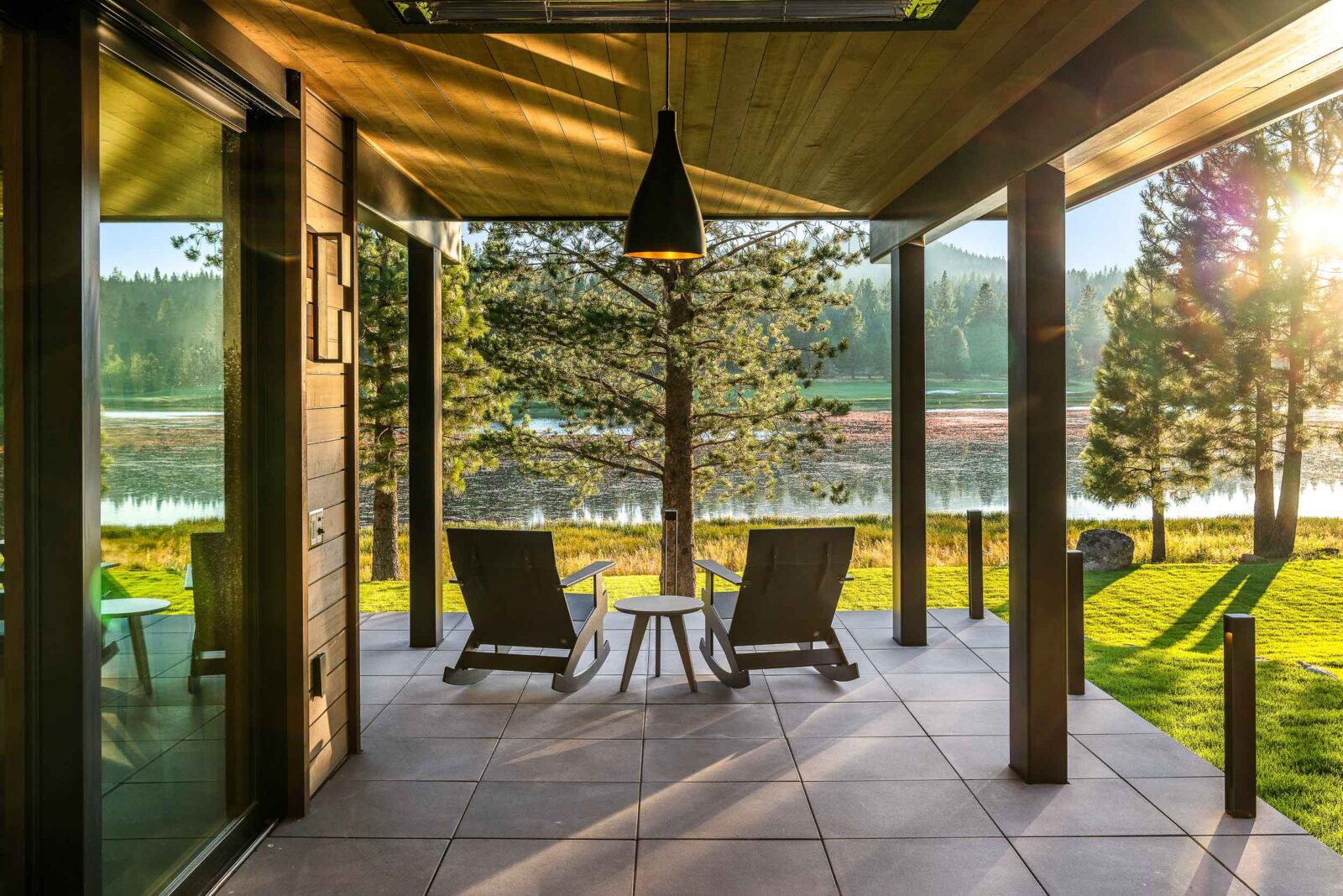 Covered and heated outdoor sitting area with views of lake and mountains. 