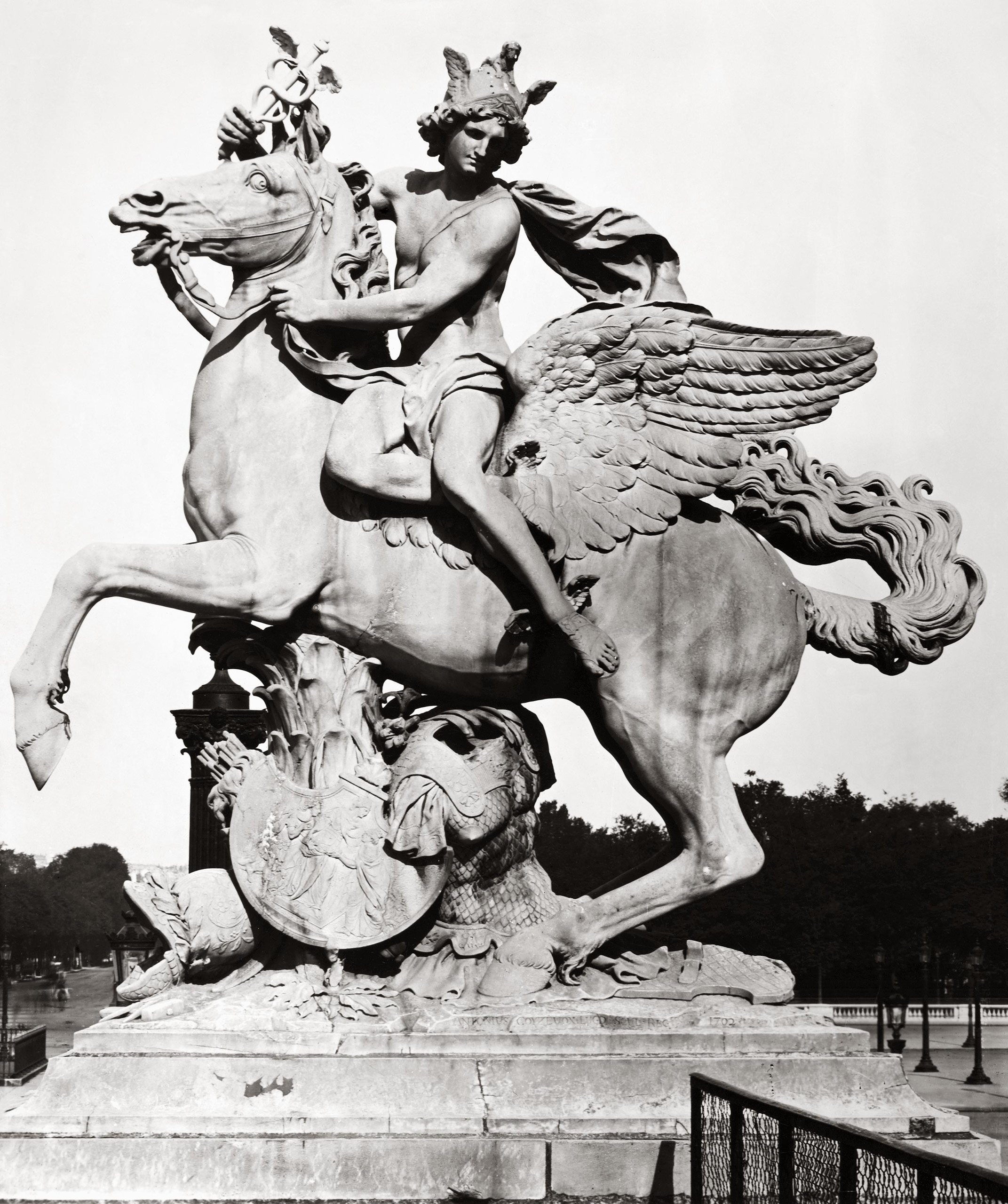 Black and white photograph of a stone statue of Pegasus with a rider