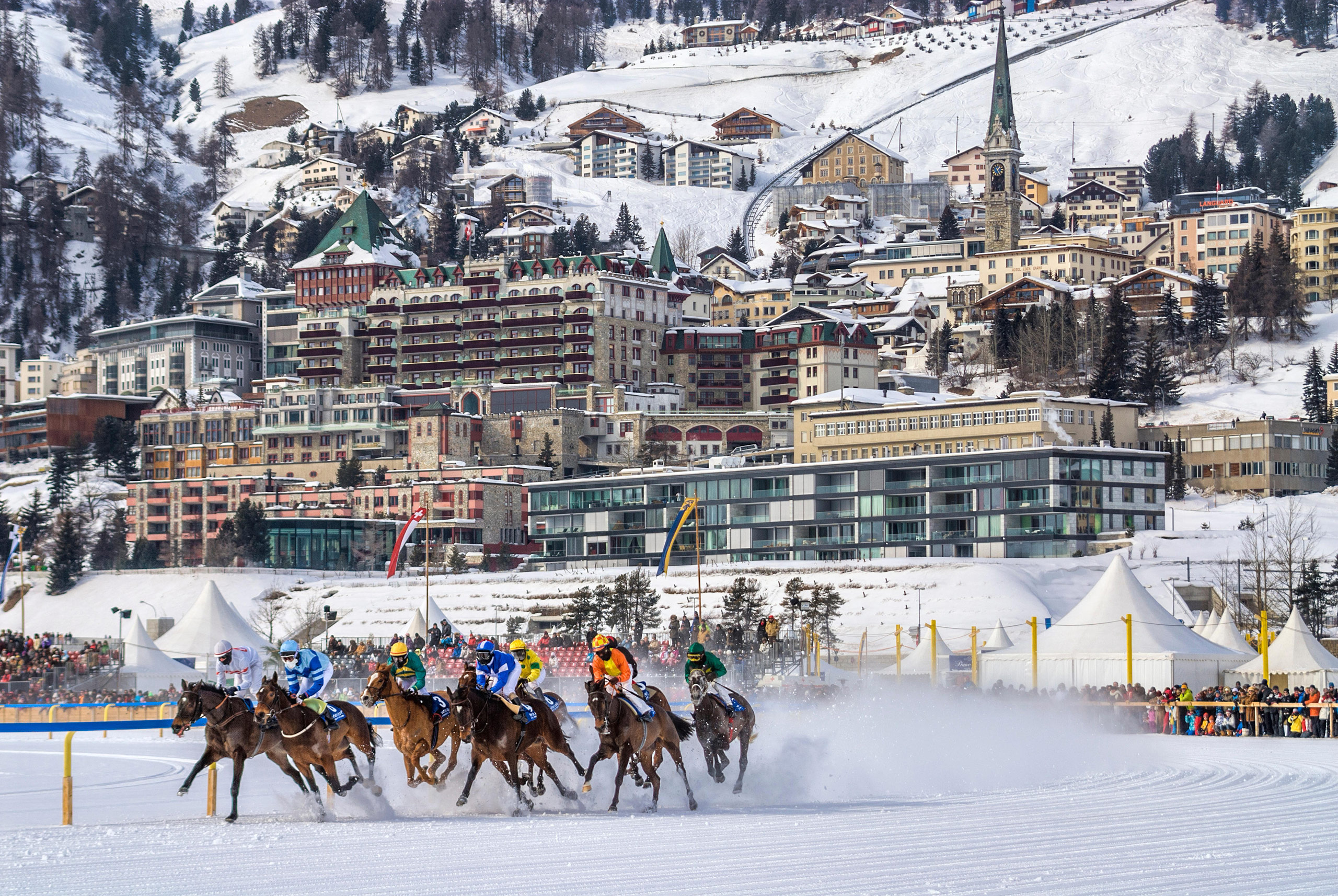 horses racing in teh snow at the foot of St Moritz