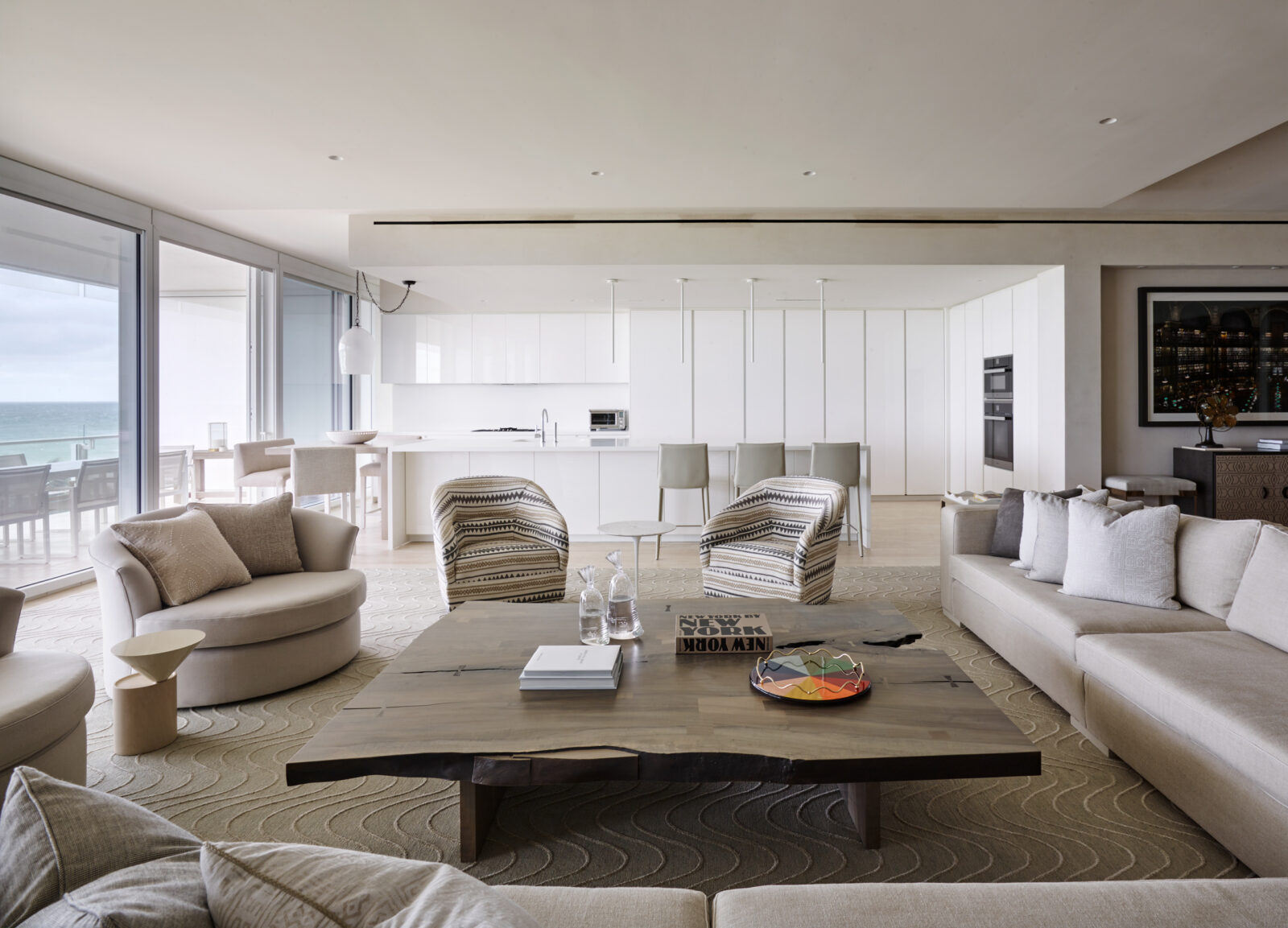 Living room with large glass doors onto terrace at Miami Surf Club