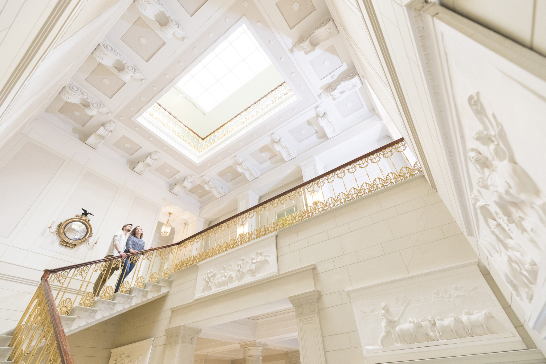 Young white couple on grand staircase inside Jenisch Haus, Hamburg, Germany