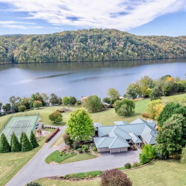 Take in the stunning lake view as you play tennis with your loved ones. (Long & Foster Real Estate)