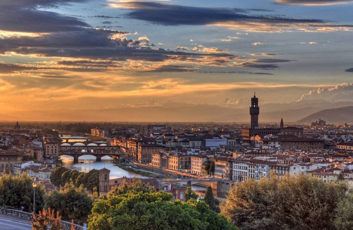 The sun sets behind Cathedral of Santa Maria del Fiore (Duomo) and Vecchio palazzo in Florence, Italy. (Building Heritage)